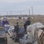 Palestinians make their way through the Netzarim Corridor